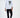 Man wearing Marcus slim fit dark blue jeans with a long-sleeved graphic white t-shirt and white sneakers.