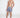 Model wearing Hank Swimwear blue floral patterned swim trunks with white drawstrings and Carbon Jeans slides.