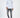 Man in a white Heartbit long sleeve graphic t-shirt and distressed gray skinny jeans for streetwear style.