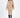 Model wearing the Destiny beige oversized cable knit turtleneck sweater with black knee-high boots.