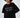 Model wearing Manhattan Top, a black oversized sweatshirt with white New York Central Park embroidery.