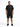 A man stands confidently in a black oversized t-shirt paired with cargo shorts and sneakers.
