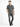 A man stands confidently in a short-sleeve black and white checkered shirt paired with distressed gray jeans.
