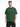 A man wearing a green oversized t-shirt with white text on the front, paired with black cargo shorts.