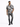 A man walks confidently in a short-sleeve, abstract-patterned shirt paired with distressed jeans and black sneakers.