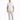 A man stands confidently in a white t-shirt with a textured graphic, paired with light gray pants and white sneakers.
