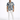 A man stands wearing a short-sleeve, blue and beige patterned shirt paired with white jeans and sneakers.