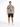 A man stands confidently in a patterned short-sleeve shirt and black shorts, paired with white sneakers.