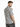 A man with a stylish haircut wears a short-sleeve shirt featuring a black and white grid pattern.