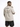 A man wearing a beige t-shirt with a graphic of dice and the phrase about life's unpredictability on the back.