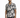 A man stands wearing a short-sleeve, abstract patterned shirt in shades of gray and black, paired with distressed jeans.