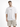 A man stands wearing a loose-fitting white t-shirt with black text, paired with beige cargo shorts.