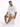 A man sits on a white cube wearing a loose-fitting white t-shirt, beige shorts, and white sneakers.