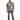 A man stands confidently in a short-sleeve, black and white patterned shirt paired with distressed jeans.