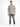 A man stands confidently in a short-sleeve, black and white patterned shirt paired with distressed gray jeans and whi...