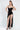 Kennedy black glitter dress featuring a sweetheart neckline, thin straps, and a high-slit skirt over mini shorts.