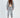 Model wearing Lily light grey matching jacket set with hooded zip-up, crop top, and drawstring joggers.