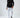 Model wearing Carlos white slim fit distressed jeans with knee rips and a black Carbon long sleeve streetwear tee.