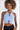 Model in light blue Tori ribbed halter crop top with keyhole cutouts and metal hardware details.