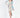 A model poses in a long-sleeve, abstract-patterned dress with a deep V-neck and side slit, showcasing a stylish look.