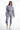 Model in lavender Elodie high-waisted joggers and cropped drawstring hoodie. Trendy women's athleisure sweatsuit bottoms.