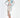 A model poses in a long-sleeve, tie-dye dress with a deep V-neck and a thigh-high slit, paired with beige heels.