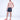 Man modeling Jaxon floral patterned swim trunks in black with red slides, showcasing trendy men's summer swimwear style.