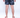 Back view of Jaxon patterned swim trunks featuring a black and white floral leaf print on a male model.