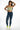 Model in Aylin high-waisted blue distressed skinny jeans with a vintage wash and slim fit against a white background.
