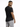 A man with short hair poses in a fitted black t-shirt and light gray shorts, showcasing a casual style.