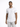 A man stands confidently in a fitted white t-shirt paired with light gray distressed jeans.