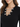 Close-up of a black top featuring a V-neckline adorned with decorative silver embellishments and rhinestones.