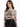 A woman models a fitted, long-sleeve top featuring intricate graphic designs and a high neckline.