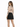 A woman with long hair wears a fitted, tattoo-printed long-sleeve top and a black mini skirt, facing away.