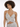 A model poses in a shimmering silver outfit with a deep V-neck and crisscross design, showcasing elegant details.