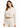 A woman models a cropped, cream-colored hoodie with a drawstring and relaxed fit, paired with matching pants.