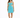 A woman stands in a fitted turquoise dress with cut-out details and thin straps, paired with black ankle-strap heels.