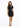 A model poses in a fitted black dress with a unique shoulder cutout, paired with strappy black heels.