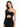 A model poses in a black, one-shoulder dress with a cutout and draped fabric, featuring subtle sparkles.