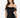 A woman models a fitted black dress with off-the-shoulder sleeves and a ruched design.