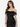 A woman models a fitted black dress with off-the-shoulder sleeves and a ruched design.