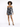 A model poses in a fitted black and white tie-dye dress with long sleeves and a ruched design.