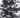 Close-up of a ruched black and white dress featuring a tie detail, showcasing a cloud-like pattern and textured fabric.