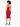 A model showcases a fitted red dress with thin straps, highlighting a sleek silhouette and stylish black heels.