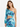 A model poses in a colorful, abstract-patterned crop top with one long sleeve and a matching skirt.
