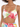 A model showcases a tropical print crop top with vibrant leaves and a knotted front detail.