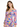 A woman models a colorful floral dress with long sleeves and a tie-front detail, featuring vibrant pink, blue, and ye...
