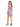 A woman stands in a colorful floral dress with long sleeves and a low back, paired with black high heels.