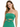 A model wearing a strapless, sparkly green top with crisscross detailing and a fitted silhouette.