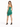 A woman in a fitted, strapless green dress with a high-low hemline, paired with black high heels.
